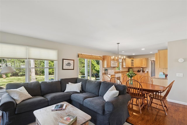 living room with recessed lighting, dark wood-style flooring, baseboards, and a chandelier