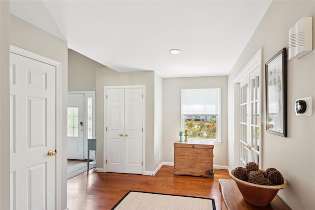 interior space featuring baseboards and wood finished floors