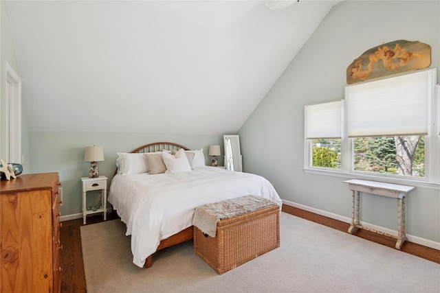 bedroom featuring baseboards, vaulted ceiling, and wood finished floors