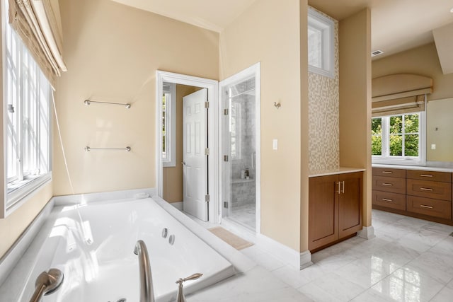 bathroom featuring vanity, visible vents, baseboards, a whirlpool tub, and a shower stall