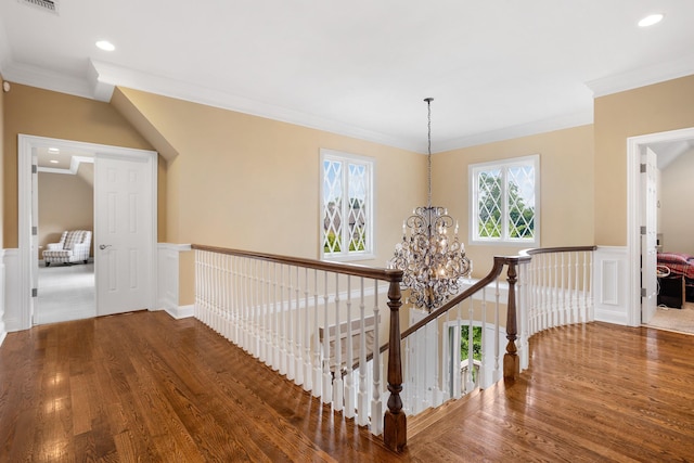 9 Earle Dr, Muttontown, NY 11791 - hallway with a chandelier, wood finished floors, ornamental molding, an upstairs landing, and wainscoting