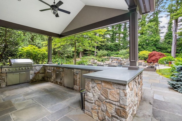9 Earle Dr, Muttontown, NY 11791 - view of patio with an outdoor kitchen, a ceiling fan, and view of wooded area