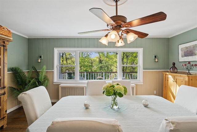 22 Washington Dr, Centerport, NY 11721 - dining area with crown molding, healthy amount of natural light, ceiling fan, wood finished floors, and wooden walls
