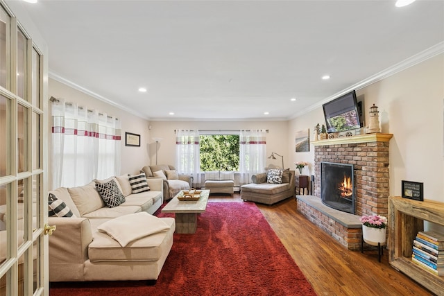 22 Washington Dr, Centerport, NY 11721 - living area featuring wood finished floors, a brick fireplace, ornamental molding, and recessed lighting