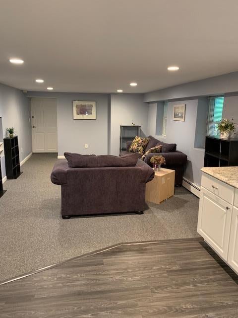 22 Washington Dr, Centerport, NY 11721 - living room with a baseboard radiator, recessed lighting, baseboards, dark wood finished floors, and dark colored carpet
