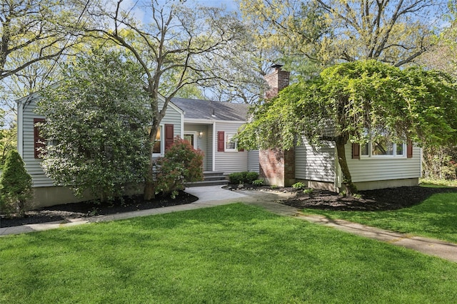 22 Washington Dr, Centerport, NY 11721 - obstructed view of property featuring a front lawn and a chimney