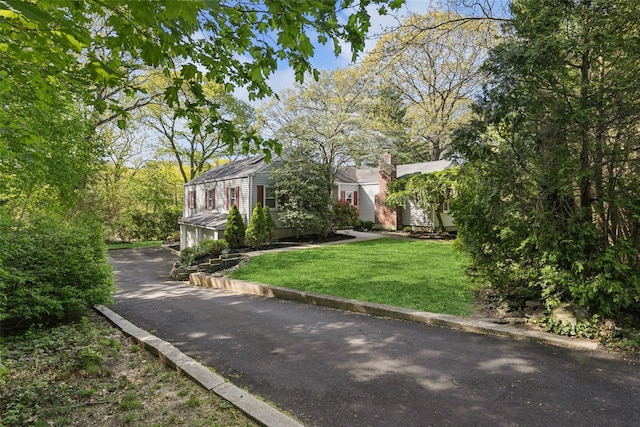 22 Washington Dr, Centerport, NY 11721 - view of front of home with asphalt driveway and a front yard