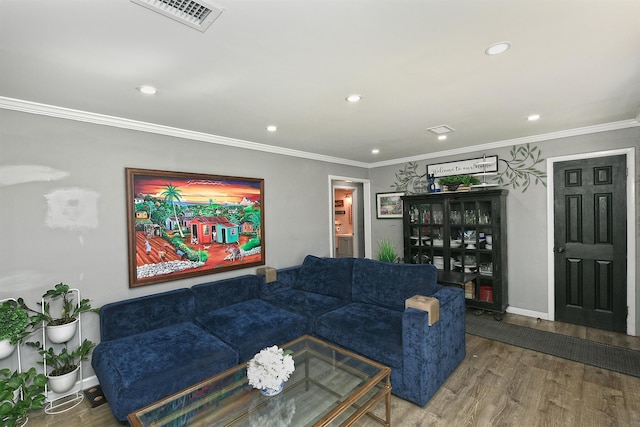 living room with crown molding, recessed lighting, wood finished floors, and visible vents