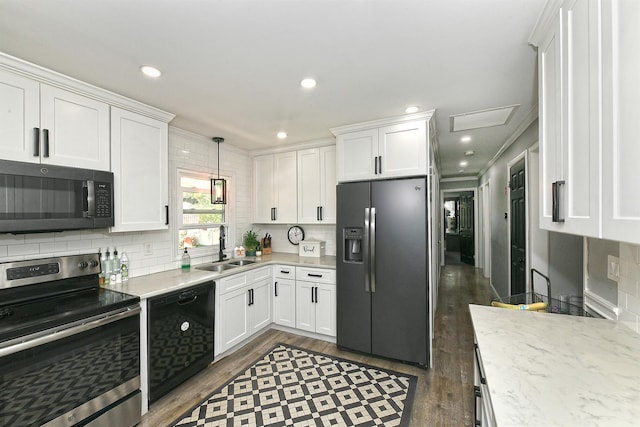 kitchen featuring dark wood-style flooring, tasteful backsplash, a sink, white cabinets, and black appliances