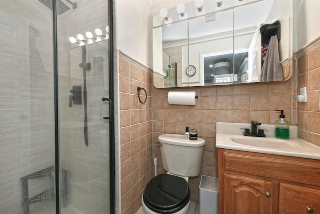 full bathroom featuring vanity, a stall shower, and tile walls