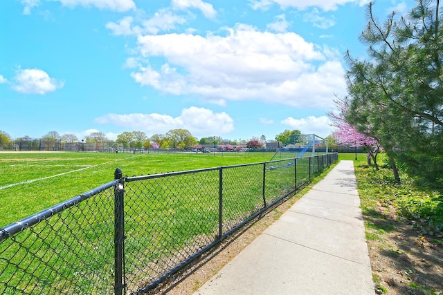 view of yard with fence and a rural view