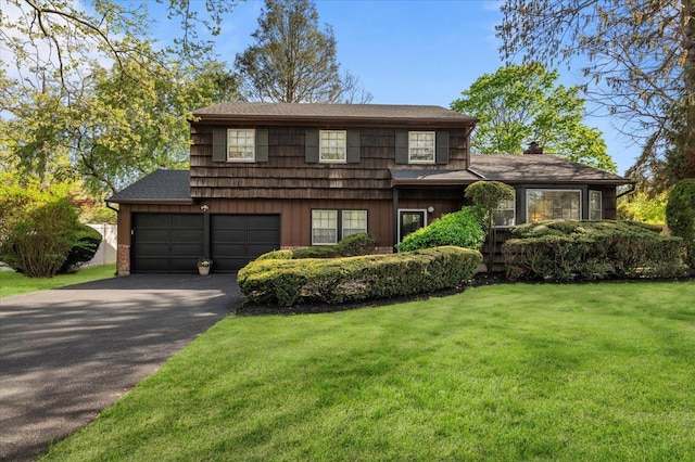 2 Yorktown Rd, Dix Hills, NY 11746 - tri-level home featuring aphalt driveway, a front yard, a chimney, a shingled roof, and board and batten siding