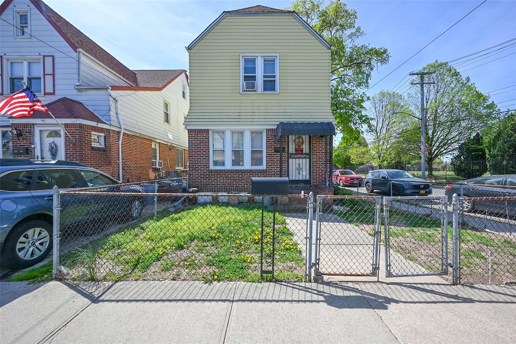 171-02 Courtney Ave, Flushing, NY 11358 - view of front of home featuring a gate, a fenced front yard, and brick siding