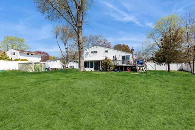 view of yard with a fenced backyard, a fenced in pool, and a deck