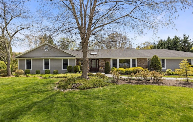 ranch-style home featuring a front yard