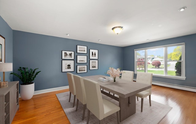 dining room featuring baseboards, baseboard heating, recessed lighting, and light wood-style flooring