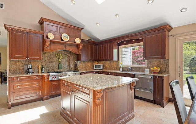 kitchen with plenty of natural light, visible vents, vaulted ceiling, and tasteful backsplash