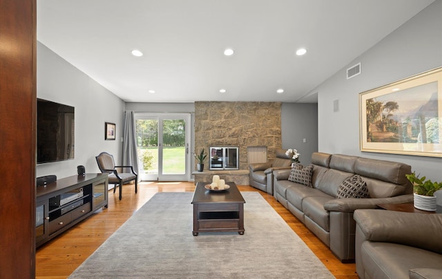 living room with recessed lighting, visible vents, and light wood finished floors