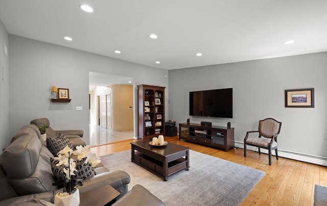 living area featuring recessed lighting, light wood finished floors, and baseboard heating