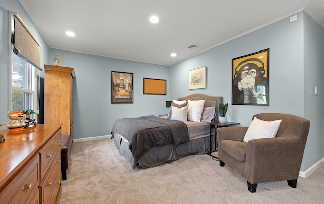 bedroom with baseboards, visible vents, and light carpet