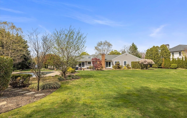 view of front of home with a front lawn and a chimney
