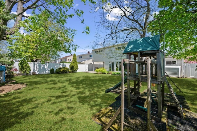 view of yard featuring fence and a playground