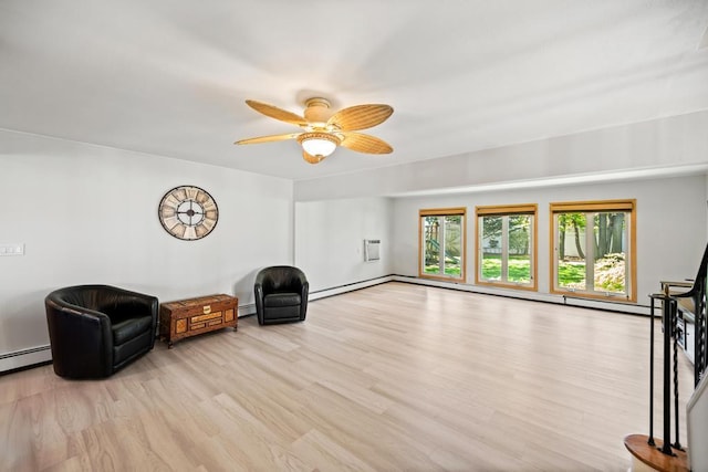 unfurnished room with a ceiling fan, a baseboard heating unit, and light wood-type flooring