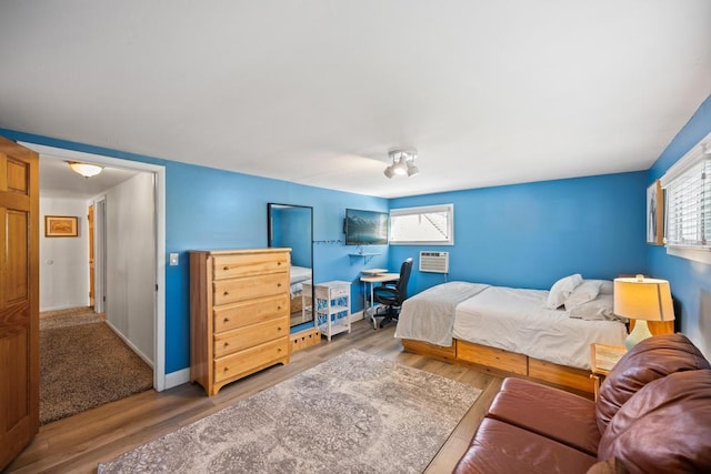 bedroom featuring baseboards and wood finished floors