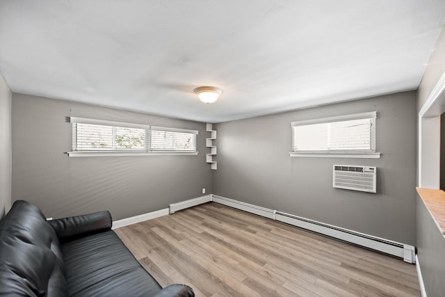 unfurnished room featuring an AC wall unit, light wood-style flooring, baseboards, and baseboard heating