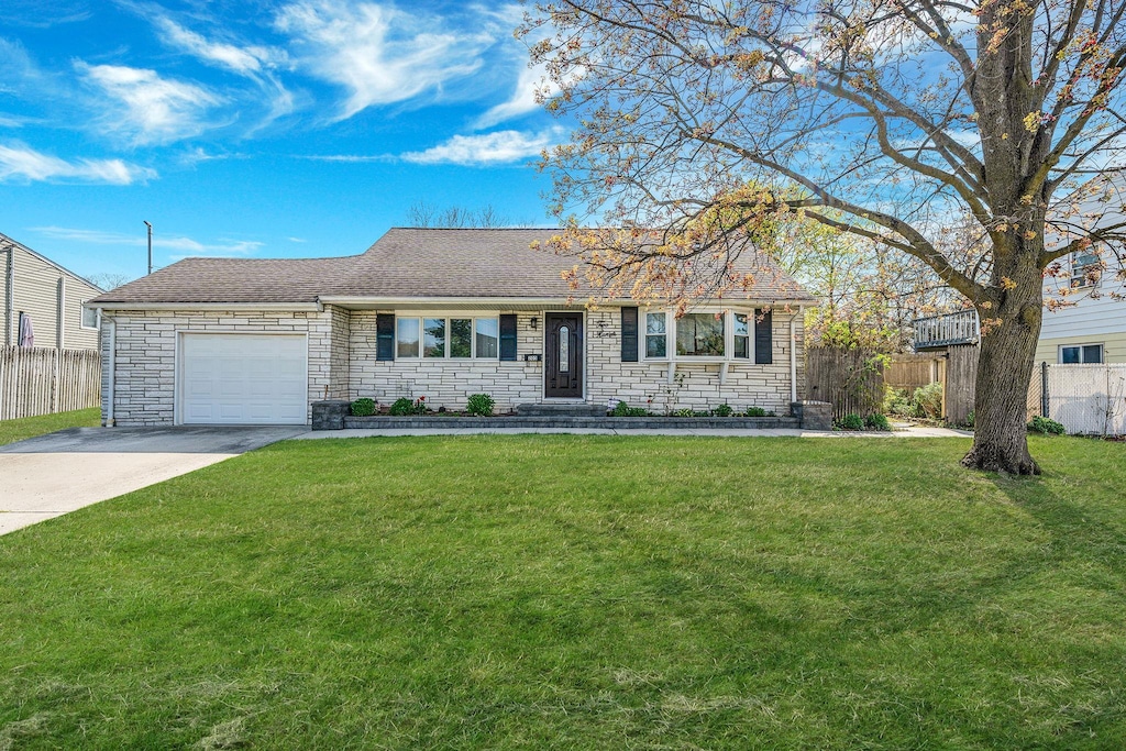 205 Westwood Dr, Brentwood, NY 11717 - ranch-style home featuring fence, concrete driveway, a garage, and stone siding