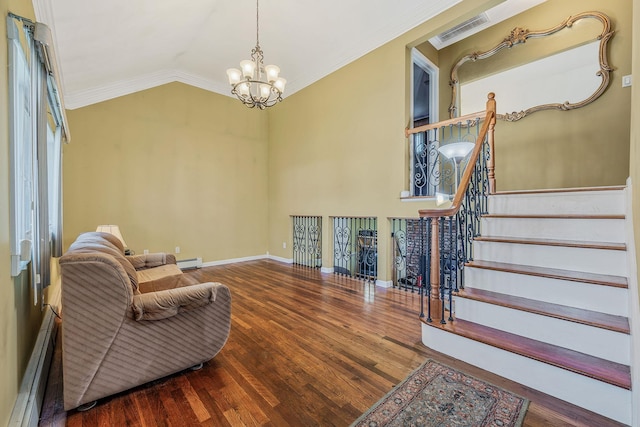living area with crown molding, a notable chandelier, wood finished floors, a baseboard radiator, and visible vents