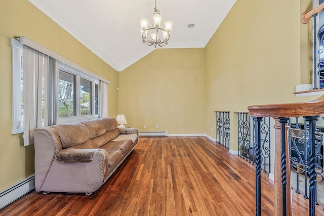 living area featuring an inviting chandelier, wood finished floors, baseboard heating, and visible vents