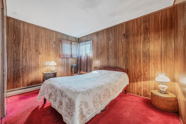 carpeted bedroom with wooden walls and baseboard heating