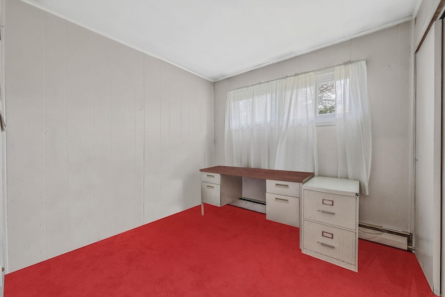 unfurnished office featuring crown molding, carpet floors, and a baseboard heating unit