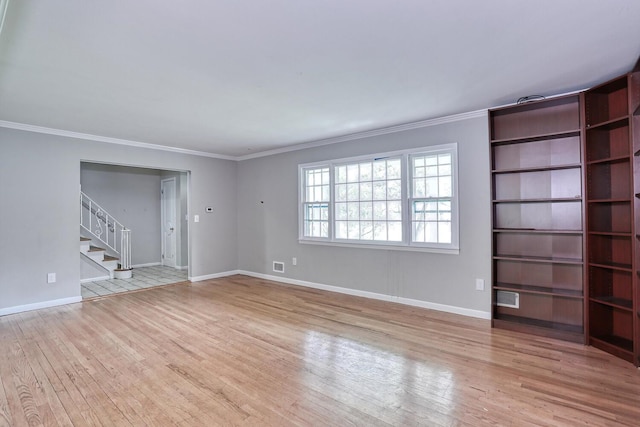 7 Macintosh Ln, Monsey, NY 10952 - unfurnished living room featuring wood-type flooring, baseboards, ornamental molding, and stairway