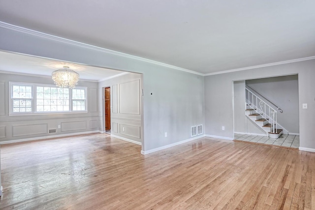 7 Macintosh Ln, Monsey, NY 10952 - unfurnished living room featuring an inviting chandelier, light wood finished floors, stairs, visible vents, and ornamental molding