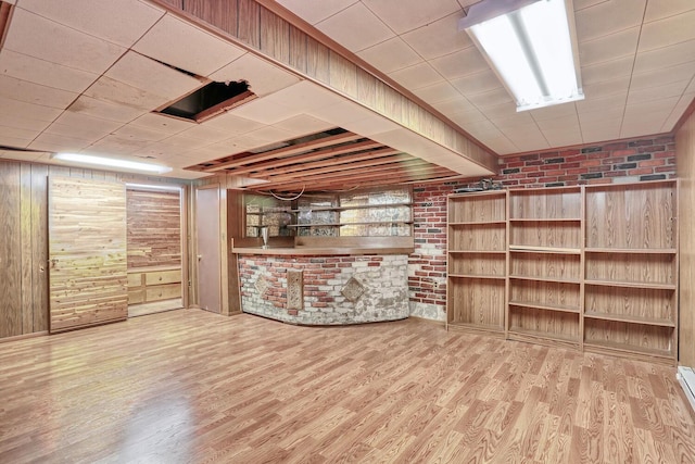 7 Macintosh Ln, Monsey, NY 10952 - finished below grade area featuring brick wall, wood walls, and wood finished floors
