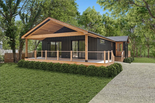 rear view of property featuring a lawn and board and batten siding