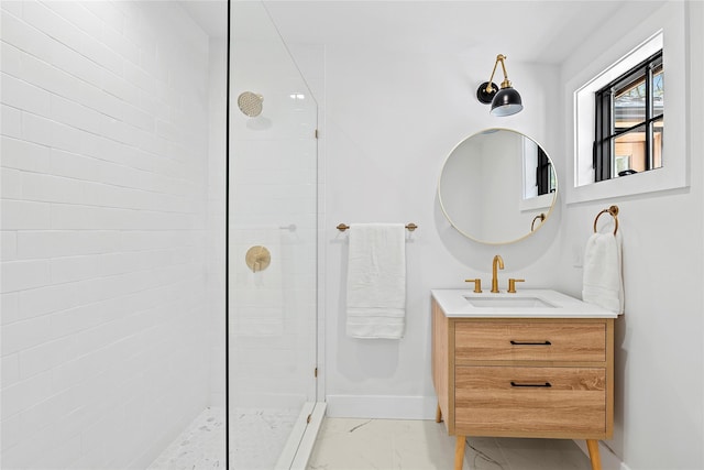 full bathroom with vanity, baseboards, marble finish floor, and a tile shower