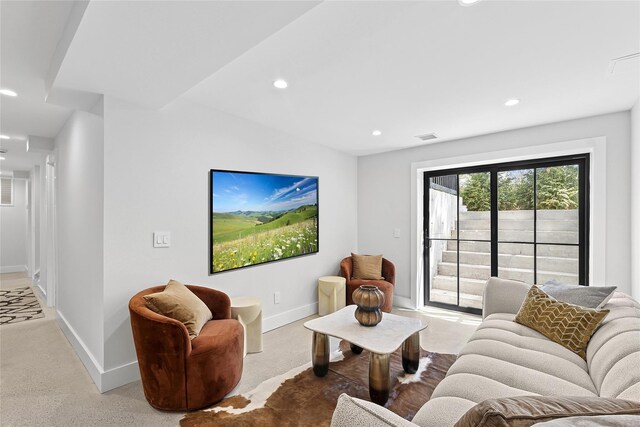 living room with concrete floors, visible vents, baseboards, and recessed lighting