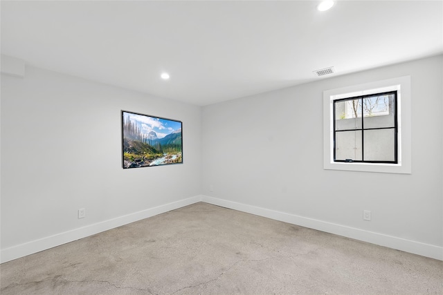 empty room featuring baseboards, recessed lighting, and visible vents