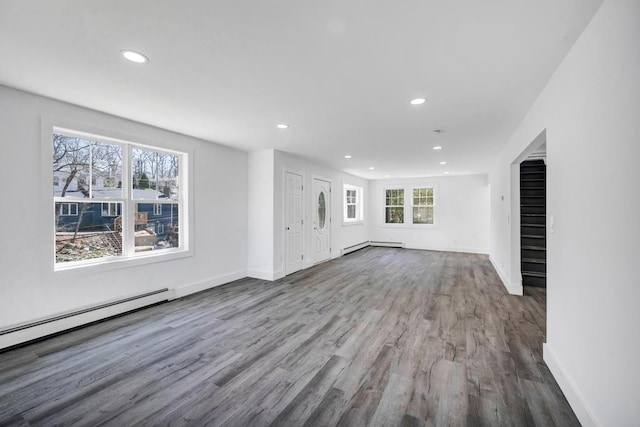 unfurnished living room featuring wood finished floors, baseboards, baseboard heating, recessed lighting, and a baseboard radiator