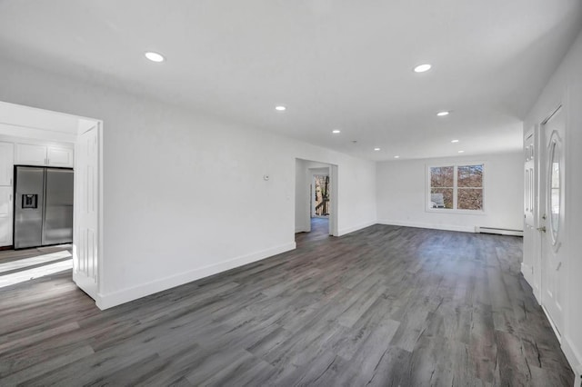 unfurnished living room featuring recessed lighting, dark wood finished floors, baseboards, and baseboard heating