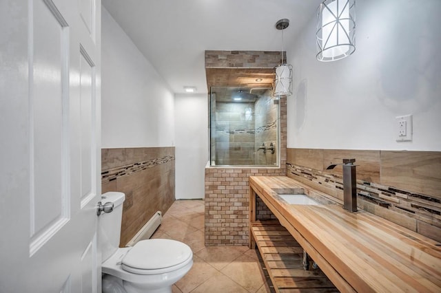 full bathroom with vanity, toilet, tile walls, tiled shower, and tile patterned floors