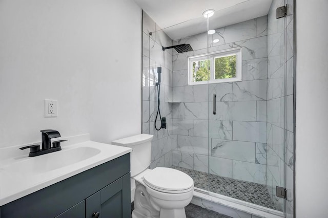 full bath featuring vanity, a shower stall, and toilet