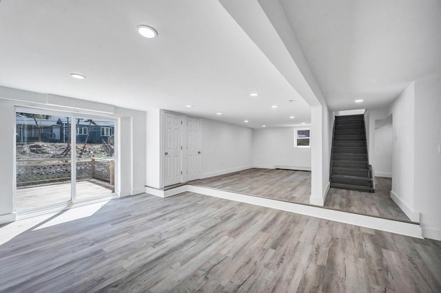 below grade area featuring recessed lighting, baseboards, and wood finished floors