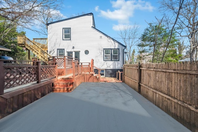 back of house with a patio, fence, a wooden deck, and stairs