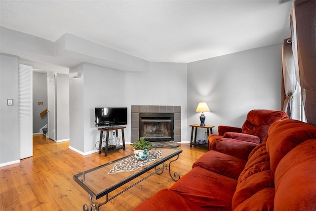 2816 Whispering Hls, Chester, NY 10918 - living room featuring wood finished floors, baseboards, stairway, and a tiled fireplace