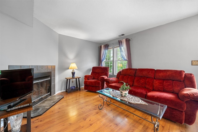 2816 Whispering Hls, Chester, NY 10918 - living room with wood finished floors, baseboards, and a tiled fireplace