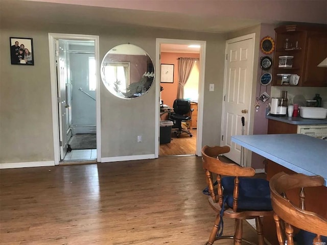dining room with baseboards and wood finished floors